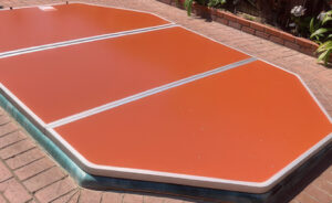 Aluminum swim spa cover installed over an outdoor swim spa.